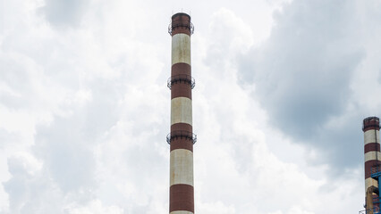 Industrial furnace and heat exchanger cracking hydrocarbons in factory on blue sky background,...