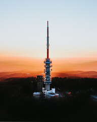 Aerial shot of Television Tower and Observation platform on top of famous Kekes Mountain during colorful sunset. Kekes Mountain,Hungary.
