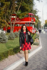 Foto op Plexiglas jonge vrouw in de buurt van Engelse bus. De rode bus van Londen - meisje dat van het leven geniet. Mooie lachende vrouw in Londen, Engeland, Verenigd Koninkrijk. Vrouw joggen training in de stad met rode dubbeldekker bus © Olga Mishyna