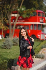 Rucksack young woman near english bus. London red bus - girl enjoying life. Beautiful smiling female in London, England, United Kingdom. Woman jogging training in city with red double decker bus © Olga Mishyna