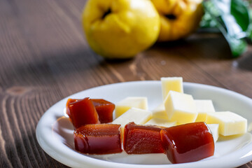 Sliced cheese and quince jam on the wood close up. Healthy fruit food concept.
