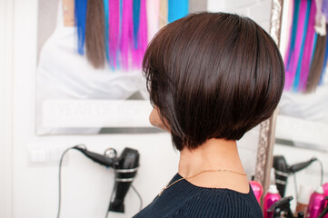 Brunette woman with short bob haircut in a beauty salon