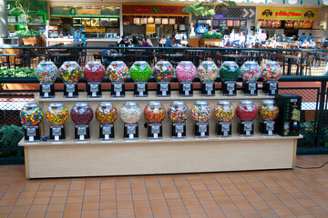 Two rows of colorful gumball machines. Mall of America MOA largest indoor retail and entertainment...