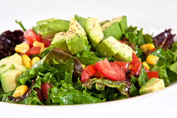Avocado salad with corn, tomato and fresh lettuce