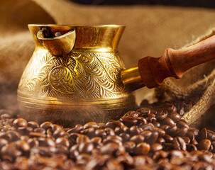 Golden cezve with freshly roasted coffee.