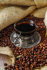 Silver coffee cup with coffee beans.
