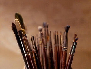 Artistic brushes for oil and acrylic painting on a warm beige background