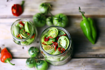 Selective focus. Jars of fermented green tomatoes. Pickling green tomatoes. Probiotics and...