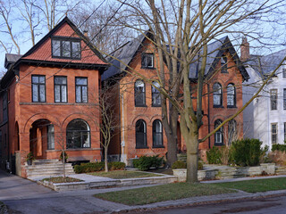 urban street with large old brick houses with gables