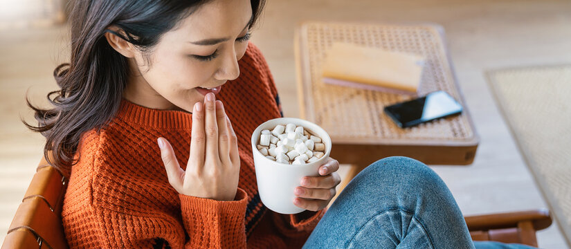 Young Beautiful Asian Woman In Sweater Hands Holding A Cup Of Coffee Morning Winter Time Relax At Home. Happy Cheerful Relaxing In Cold Winter, Barista Lifestyle Concept Banner