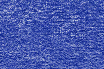 Blue painted relief wall with concrete texture.