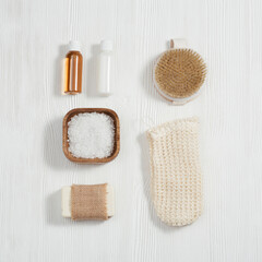 Fototapeta na wymiar Flat lay composition with bath accessories with small bottles with gel and shampoo, soap, sea salt, washcloth