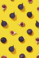 Fresh figs whole and sliced figs on yellow background. Food pattern.