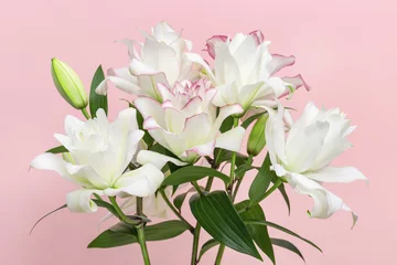 Foto op Canvas Bouquet of white lily flowers, close up peony lily on pink background. © yrabota