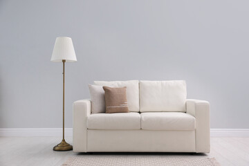 Simple room interior with comfortable white sofa