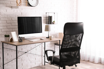 Comfortable chair near desk in modern office interior