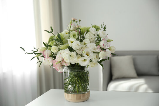 Bouquet of beautiful flowers on table in living room. Interior design