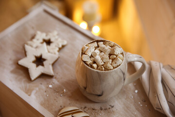 Tasty hot drink with marshmallows and cookies on wooden table