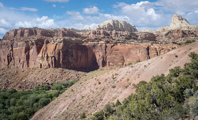 Golden sandstone geographical formations with a desert prairie landscape on a hot summer day at the Cohan Canyon Trail in Capitol Reef National Park Southern Utah.