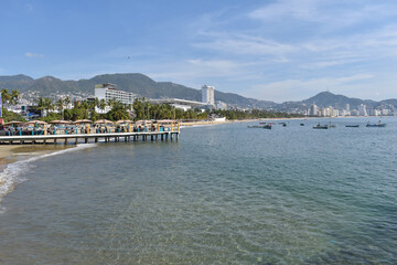 View of the bay of Acapulco with a small pier and some buildings