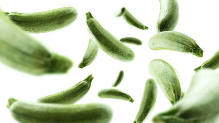 Green zucchini levitate on a white background