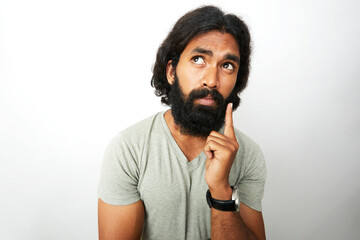 Young man thinking in wide angle shot on white.