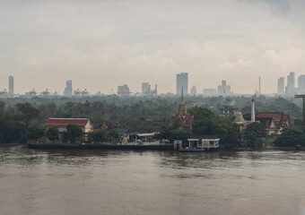 Aerial view Overlooking green area of Bang kachao lung and Bang Krachao Nok Temple Pier with a Chao Phraya River front. Focus and blur.