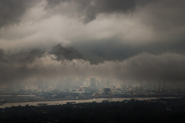 Fototapeta na wymiar Bangkok, thailand - Oct 16, 2020 : PM 2.5 or Heavy smog was covered the Bangkok building the morning.There are air pollution under heavy cloud. Focus and blur.