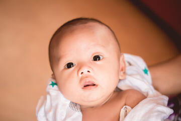 Portrait of new born baby boy resting in mothers arms,family concept,cose up.