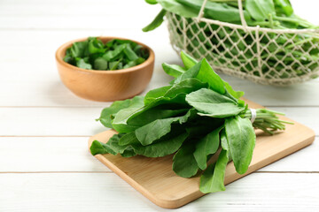 Fresh green sorrel leaves on white wooden table, closeup