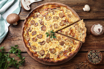 Delicious pie with mushrooms and cheese on brown wooden table, flat lay