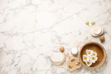 Fototapeta na wymiar Flat lay spa composition with cream on white marble table, space for text