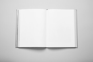 Open book with hard cover on white background, top view