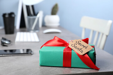 Present from secret Santa on grey table in office, space for text