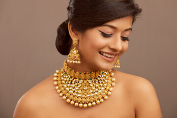 Beautiful Indian young women portrait with Indian traditional jewelry studio shot.