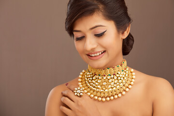 Beautiful Indian young women portrait with Indian traditional jewelry studio shot.