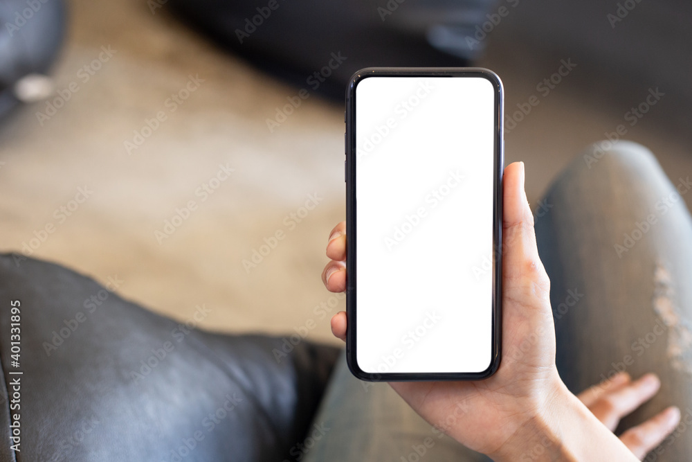 Wall mural cell phone blank white screen mockup.woman hand holding texting using mobile on desk at office.backg