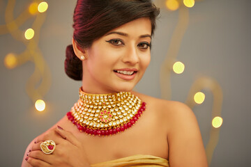 Beautiful Indian young women portrait with Indian traditional jewelry studio shot.