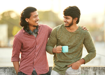 Cheerful young friends chatting on terrace.