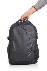 Hand holding black backpack on white background