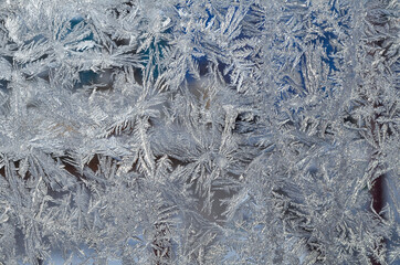 Frost patterns on the frozen window. Frost texture, Christmas background.