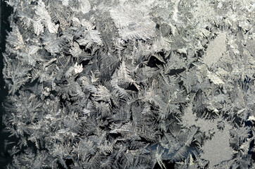 Frost patterns on the frozen window. Frost texture, Christmas background.