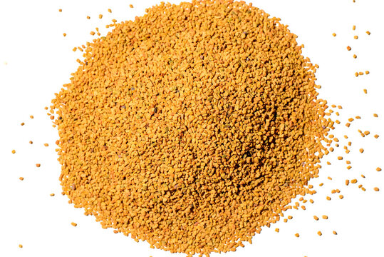 Heap of Helba Egyptian tea isolated on white background, top view. Scattered grains of yellow tea.