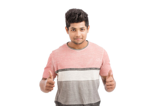 Handsome Indian young man showing thumbs up isolated on white.