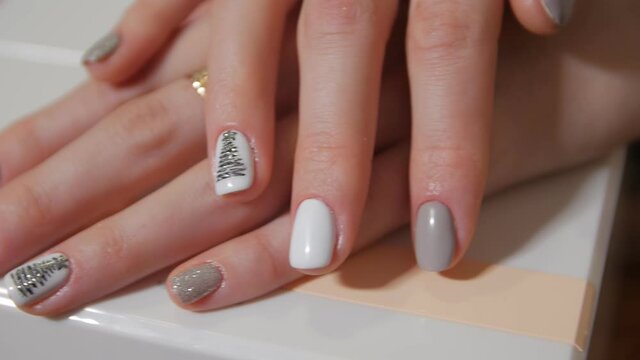 Christmas tree art drawing and star nails manicure closeup pan shot