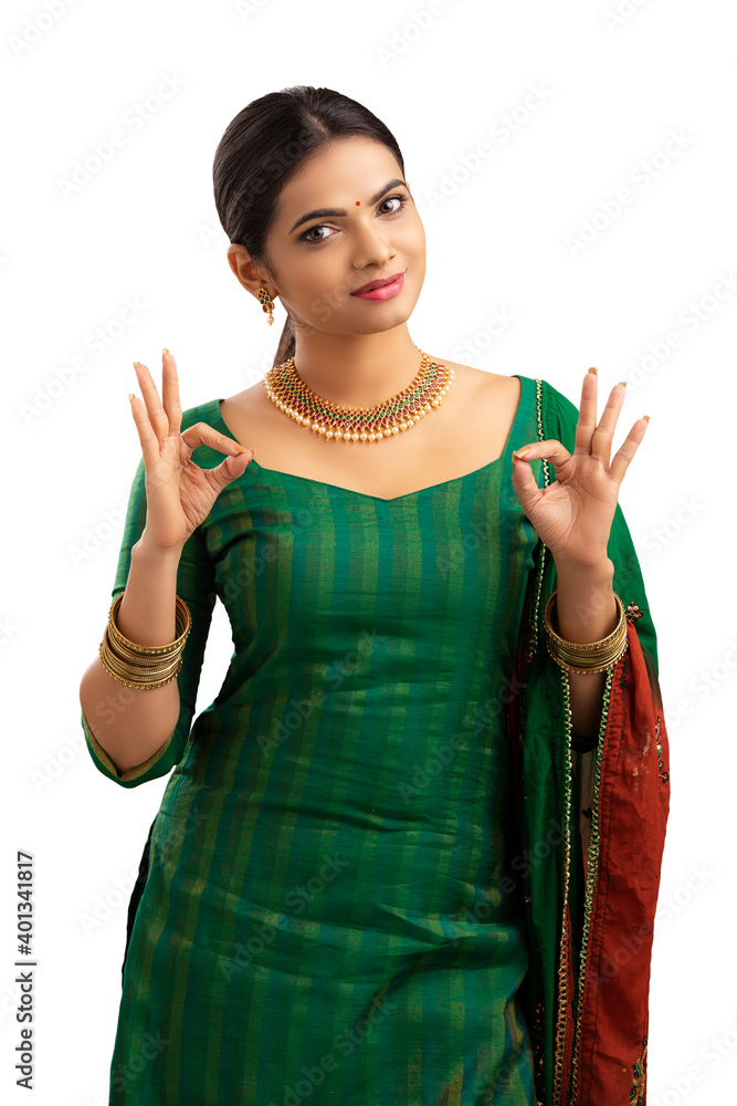 Wall mural pretty indian young girl showing best hand sign.