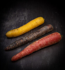 Multicolor carrots on grey background
