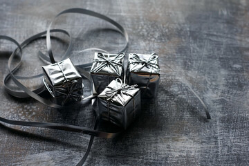 Silvery boxes with gifts on a dark background. Holiday concept, New Year