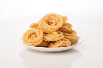 Chakli the savoury indian spicy snack on white.
