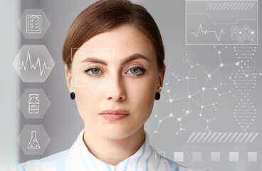 Young woman with iris scanning on grey background